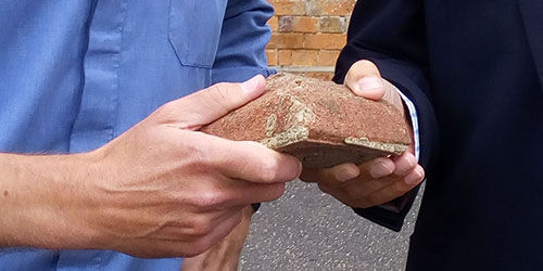 two hands holding building block